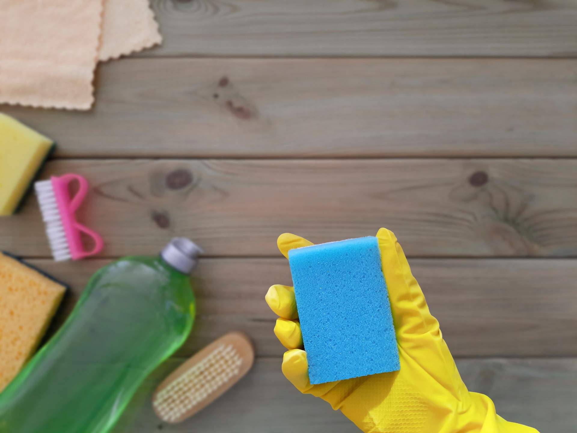 Kitchen sponge in hand. Flat lay. Concept of spring Deep clean of house. Place for text.